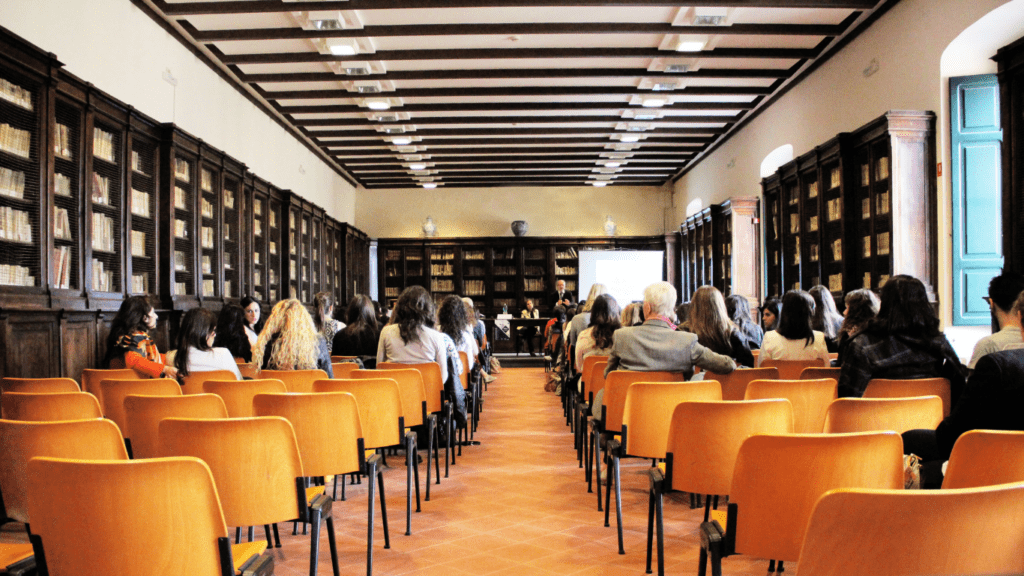 A person giving a presentation in front of a large audience