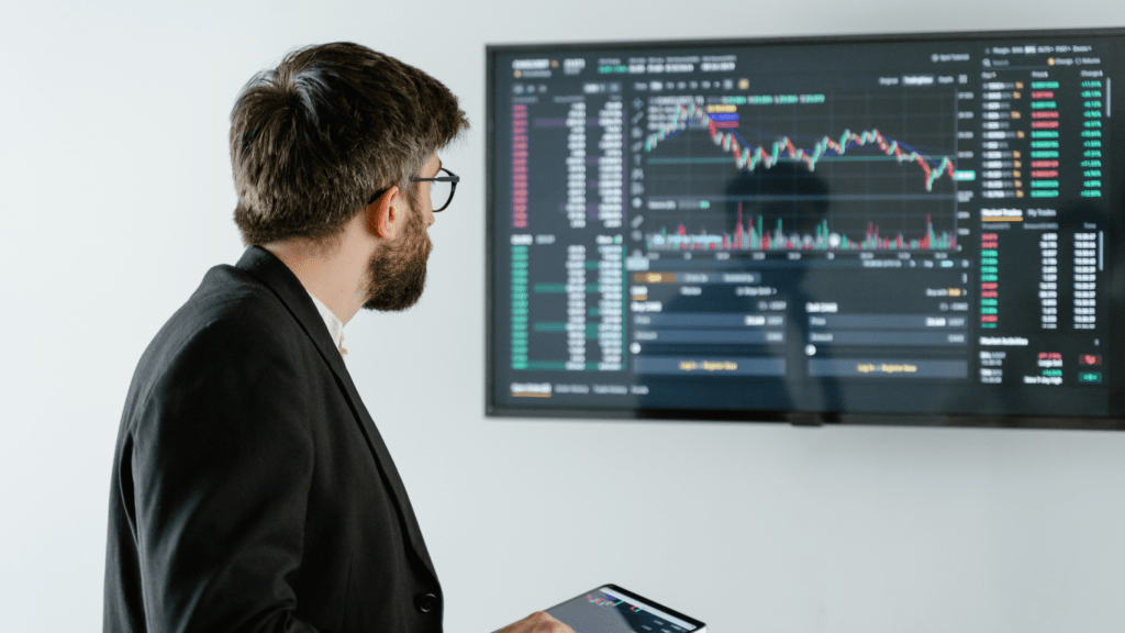 man in black suit reading crypto chart