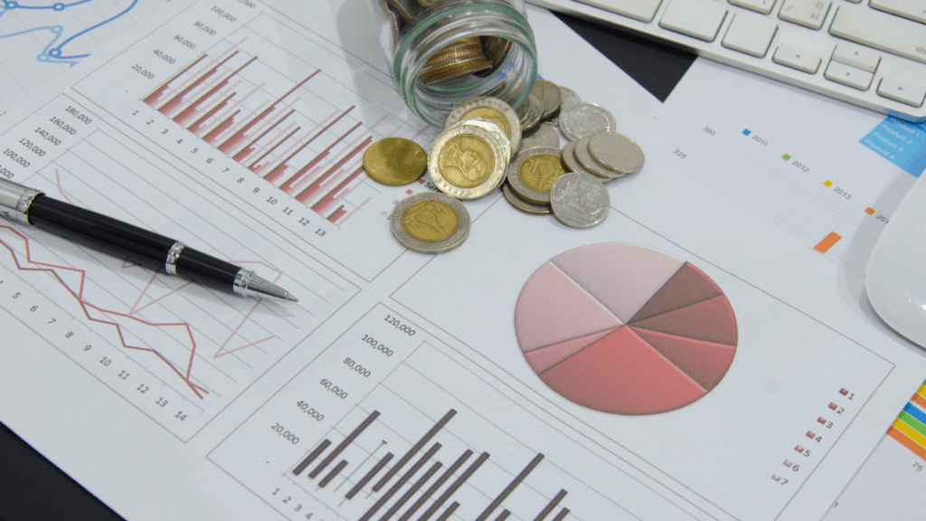 money, coins and graphs on a desk