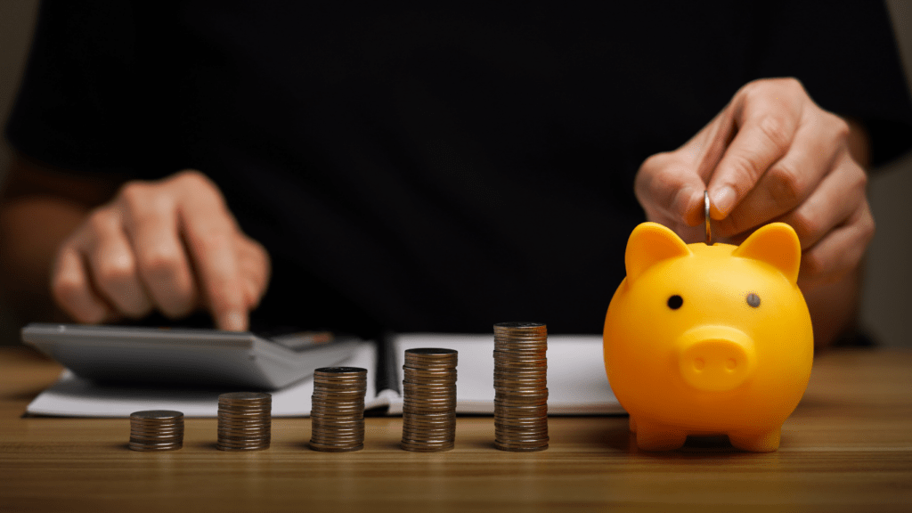 piggy bank with coins on wooden table